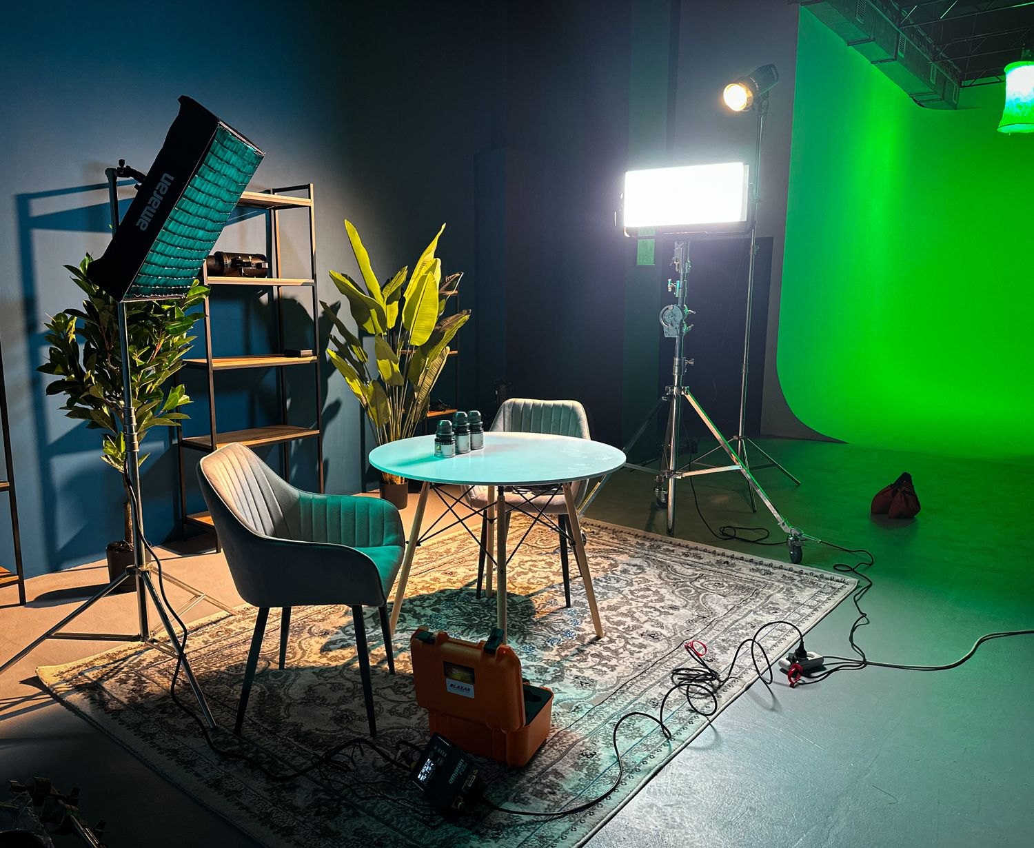 A filming room with lights, furniture and cable routes.