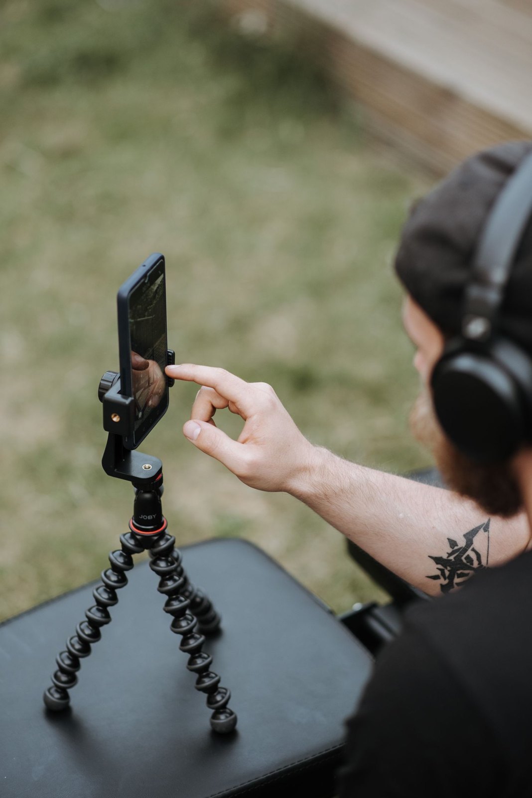 A phone on a tripod being adjusted for a recording.