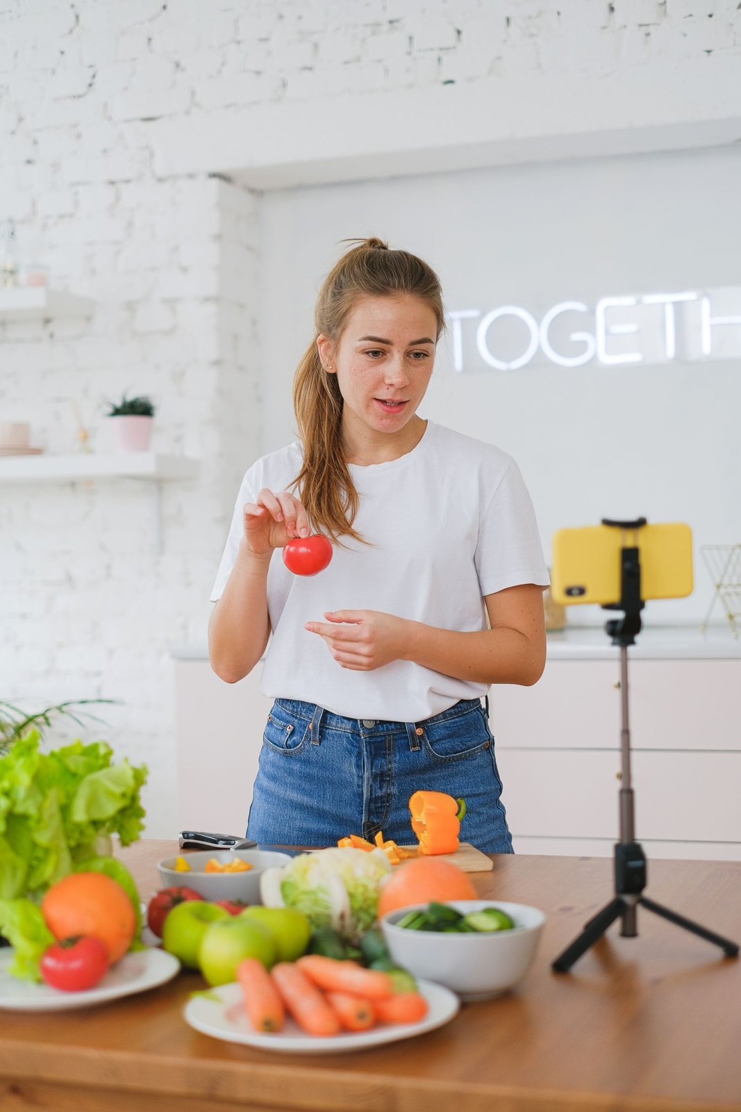 A presenter explaining food preparation to a smartphone camera.