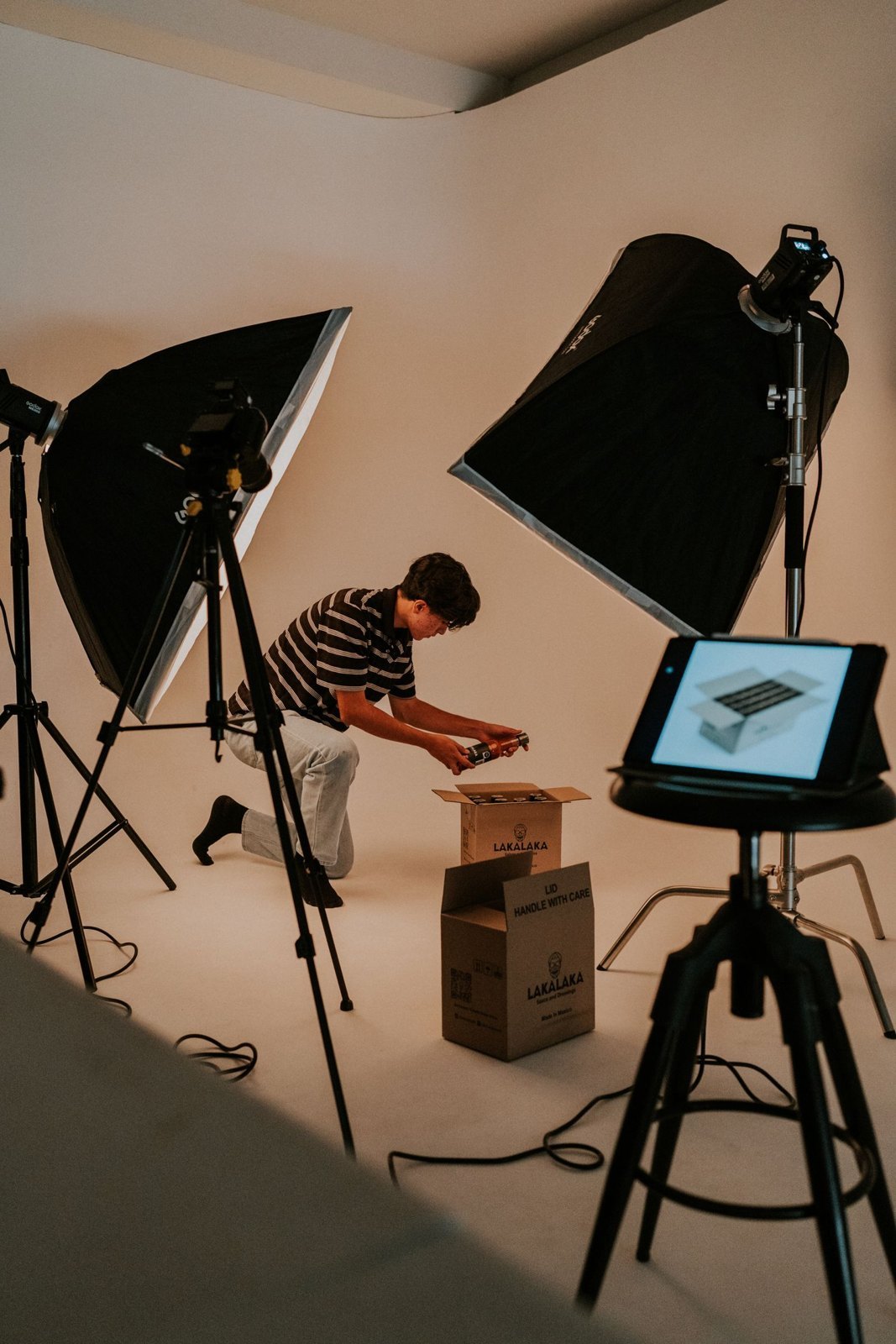 An unboxing being prepared with studio lighting and recording equipment.